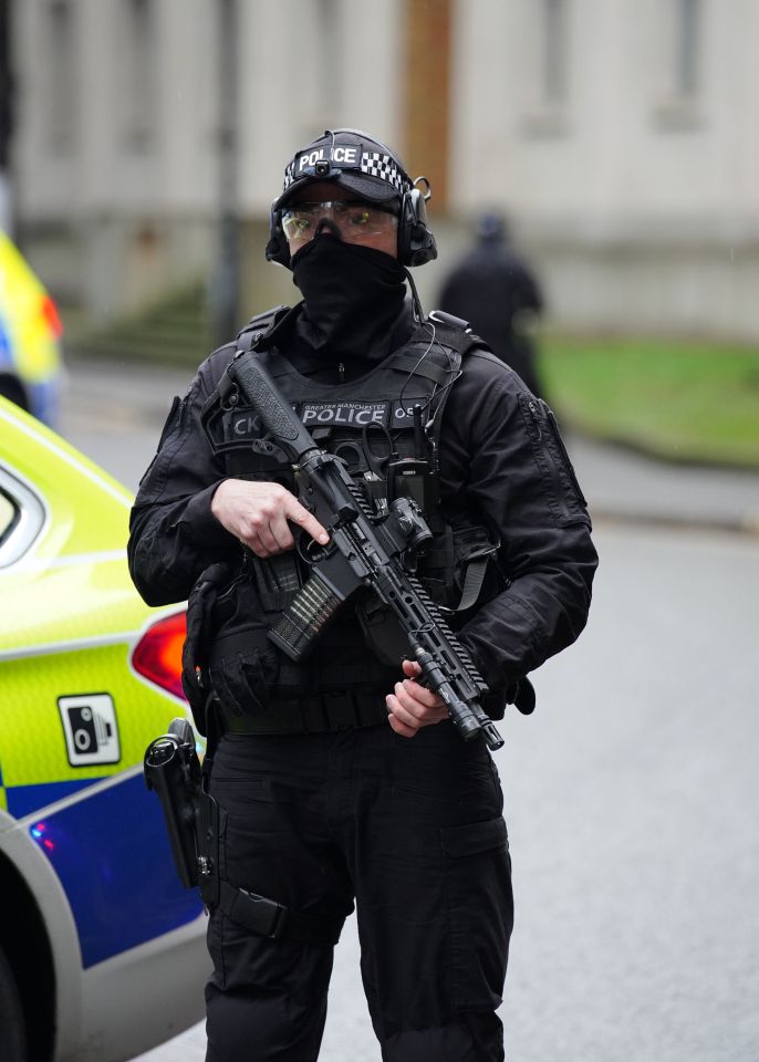 An armed police officer outside the court on March 6