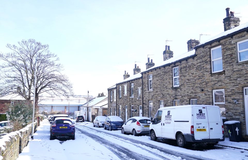 Snow covers cars and a small street in Cleckheaton, West Yorkshire