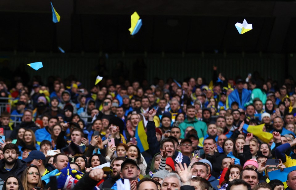 Ukraine fans launch paper planes on to the pitch