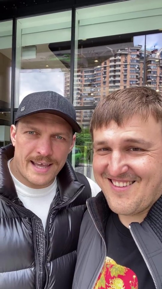 Alex Krassyuk, pictured with Oleksandr Usyk, doubts that the April 29 showdown will happen