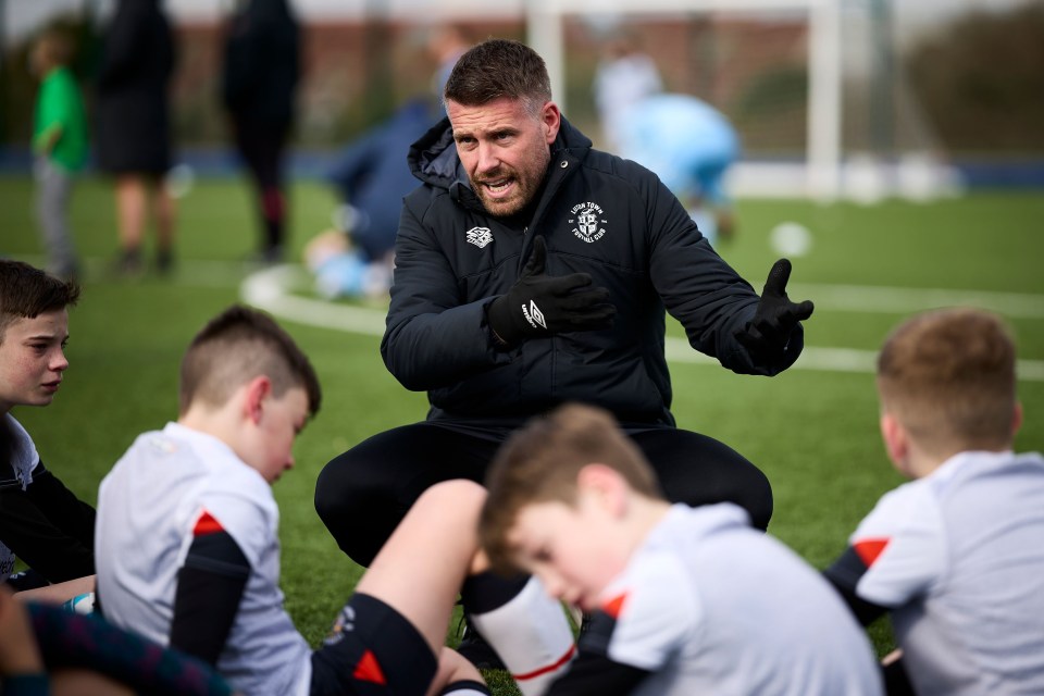 Rob Edwards consoles the young Hatters after their defeat to Watford