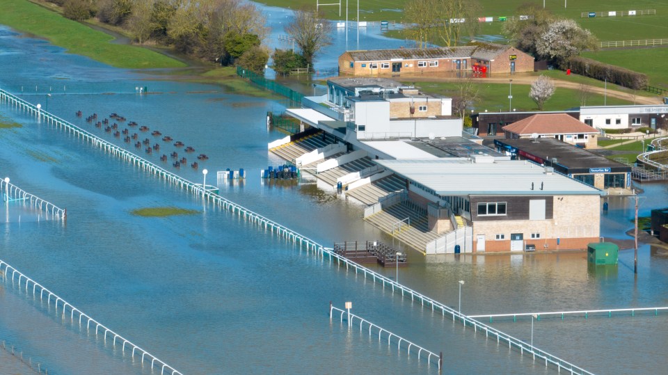 Extraordinary pictures show Huntingdon Race Course in Cambridgeshire completely submerged while drivers battled flooded roads