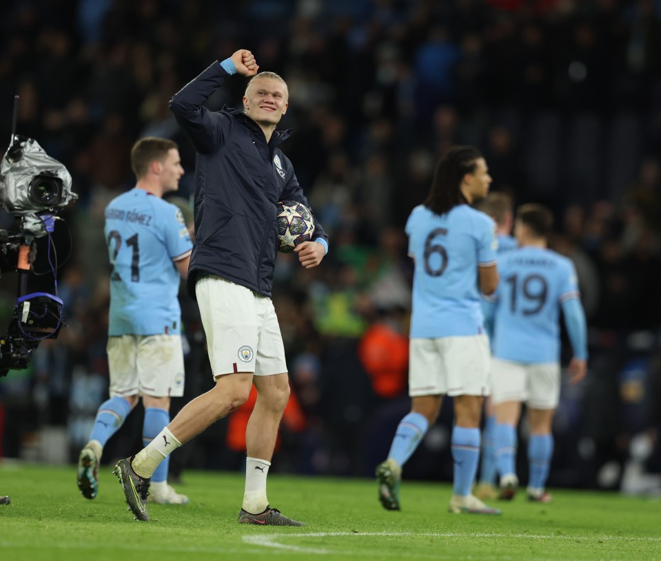 The Norwegian striker celebrating at full-time with the match ball