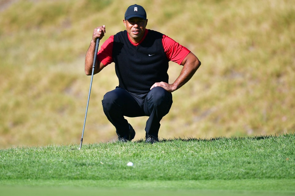 Tiger Woods lines up a putt at the Genesis Invitational in February 2023