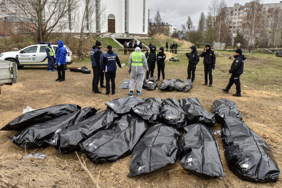 epa09887828 Bodies are exhumed and removed from the mass grave near the St. Andrew and All Saints Church in Bucha city of Kyiv (Kiev) area, Ukraine, 13 April 2022. Forensic investigators began exhuming a mass grave in Bucha containing more than 410 bodies of civilians, according to Ukrainian officials. The UN Human Rights Council has decided to launch an investigation into the violations committed after Russia's full-scale invasion of Ukraine, the Ukrainian Parliament reported. Russian troops entered Ukraine on 24 February resulting in fighting and destruction in the country and triggering a series of severe economic sanctions on Russia by Western countries. EPA/OLEG PETRASYUK