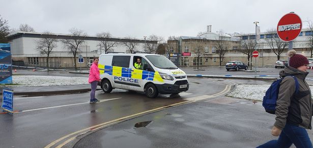 Police vehicles remained at the scene today