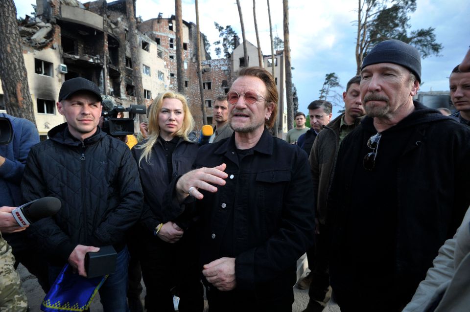 U2's Bono and The Edge, who have been invited to play, visit the Ukrainian town of Irpin