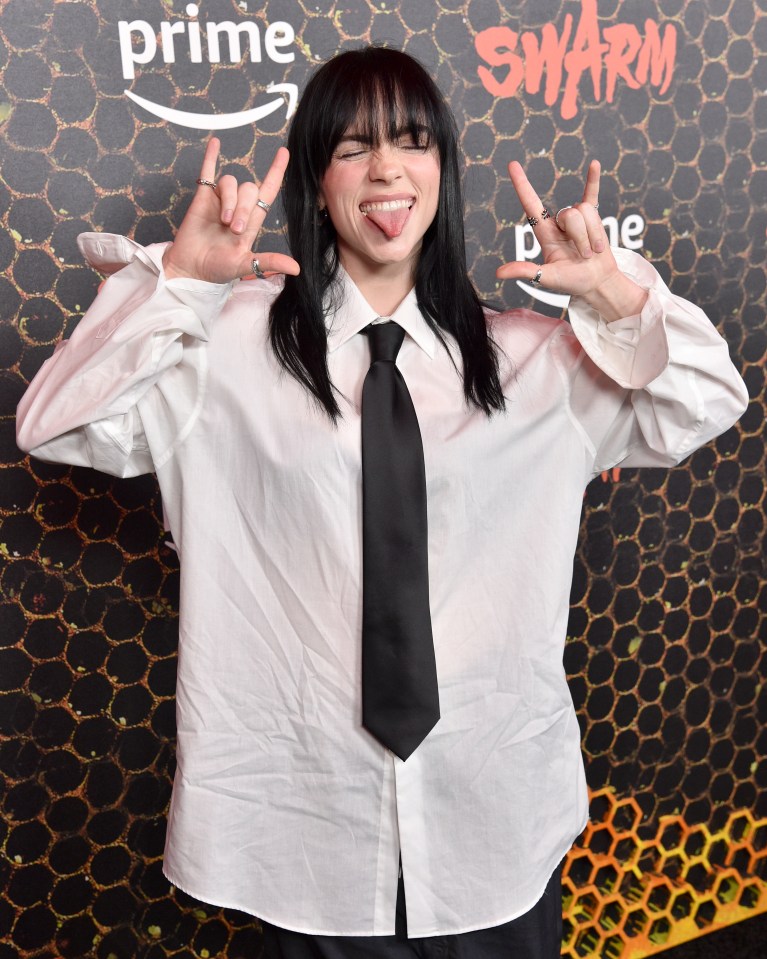 The singer posed in an oversized white shirt with the tie for the launch of new horror Swarm