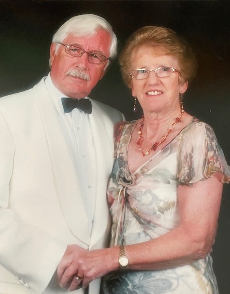 The retired midwife, pictured with her husband David, was declared dead at the scene