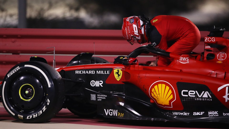 Charles Leclerc climbs out of his Ferrari after it loses power in Bahrain