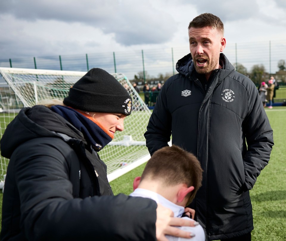 A young Hatter is sobbing in front of Rob Edwards after losing to Watford