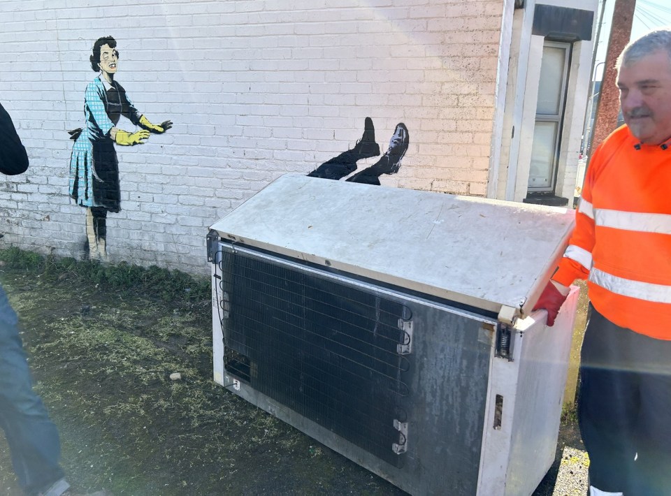 A council worker removing the freezer