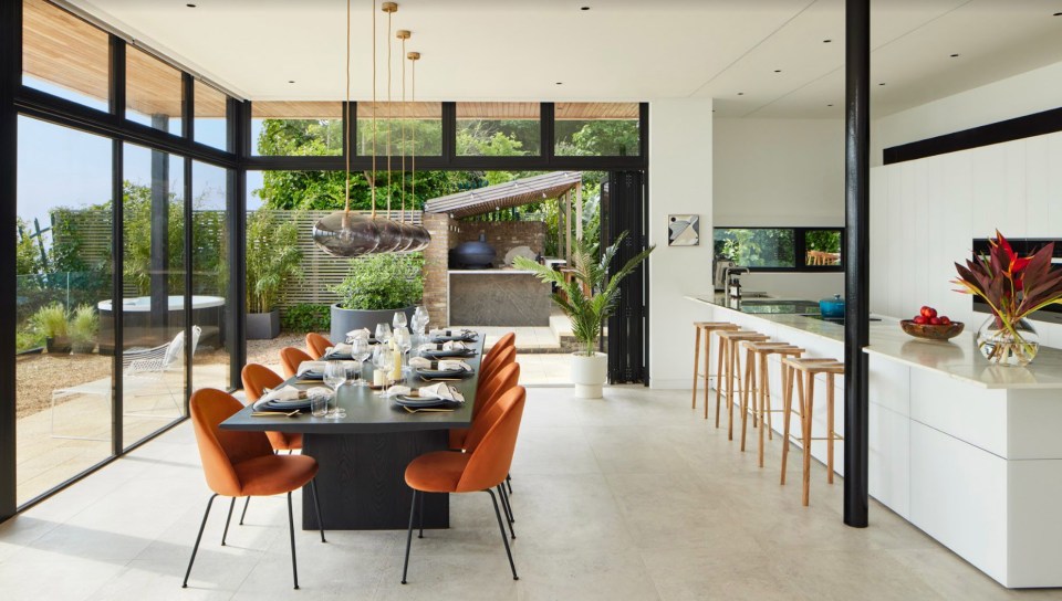 The kitchen features a long island, breakfast bar and dining area