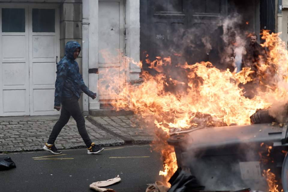 Protesters set fire to bins during a demonstration in Lille, northern France