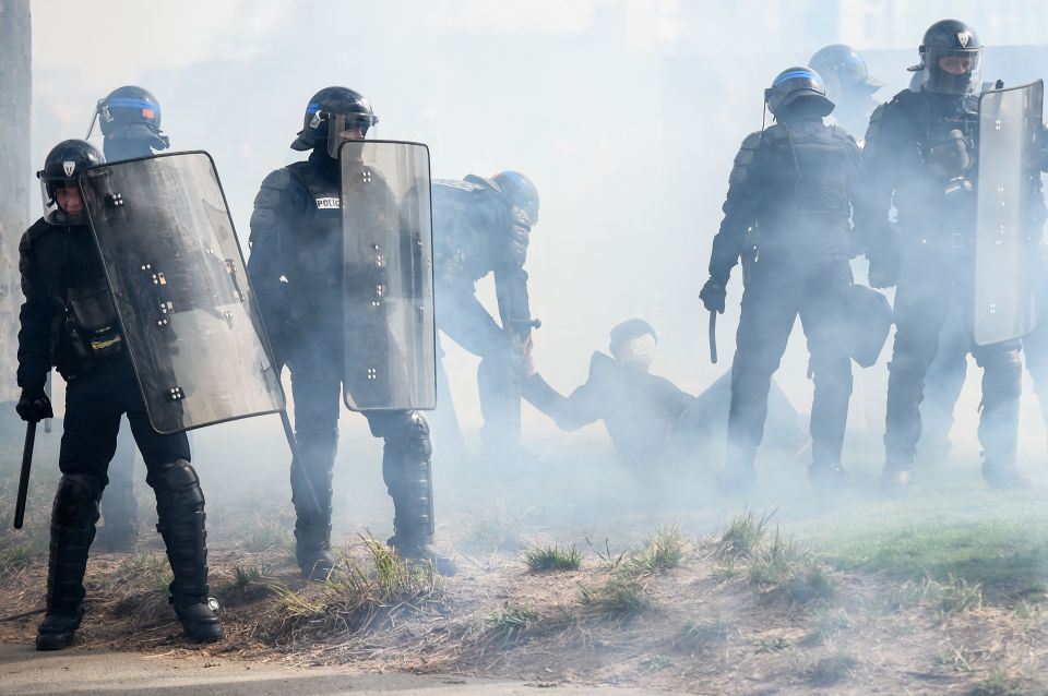 Cops arrest a protester during clashes in Nantes, western France