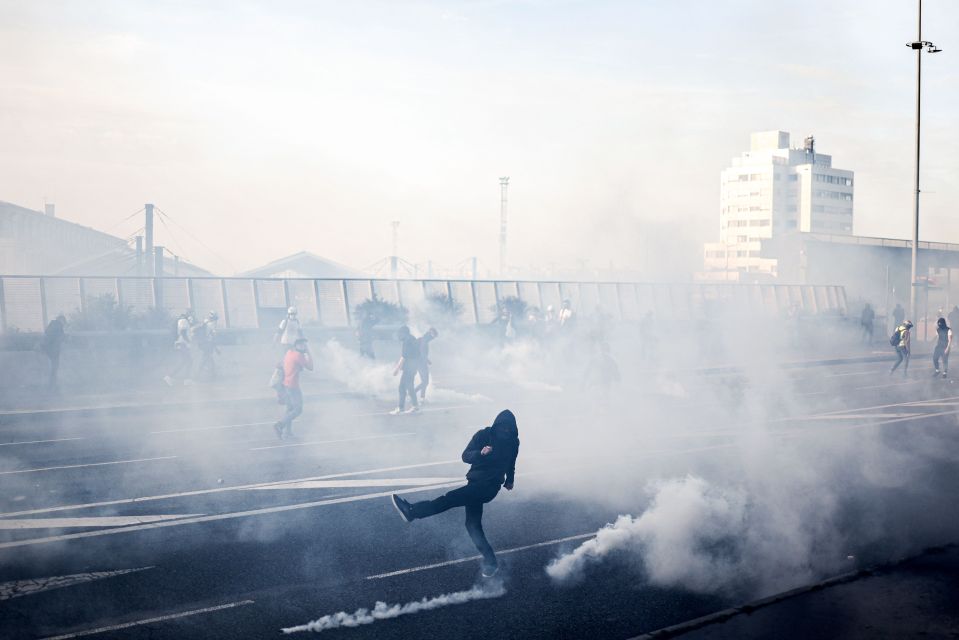 A protester stands among tear gas in Toulouse, southern France