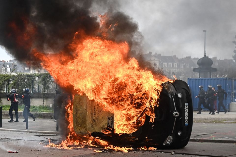 A car burns during clashes between protesters and cops in Nantes, western France