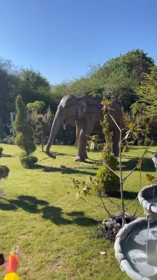 Continuing the animal theme, Gemma's garden features an elephant statue amongst the trees