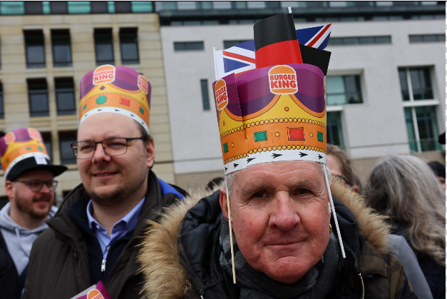 Many of those in the crowd donned the paper crowns