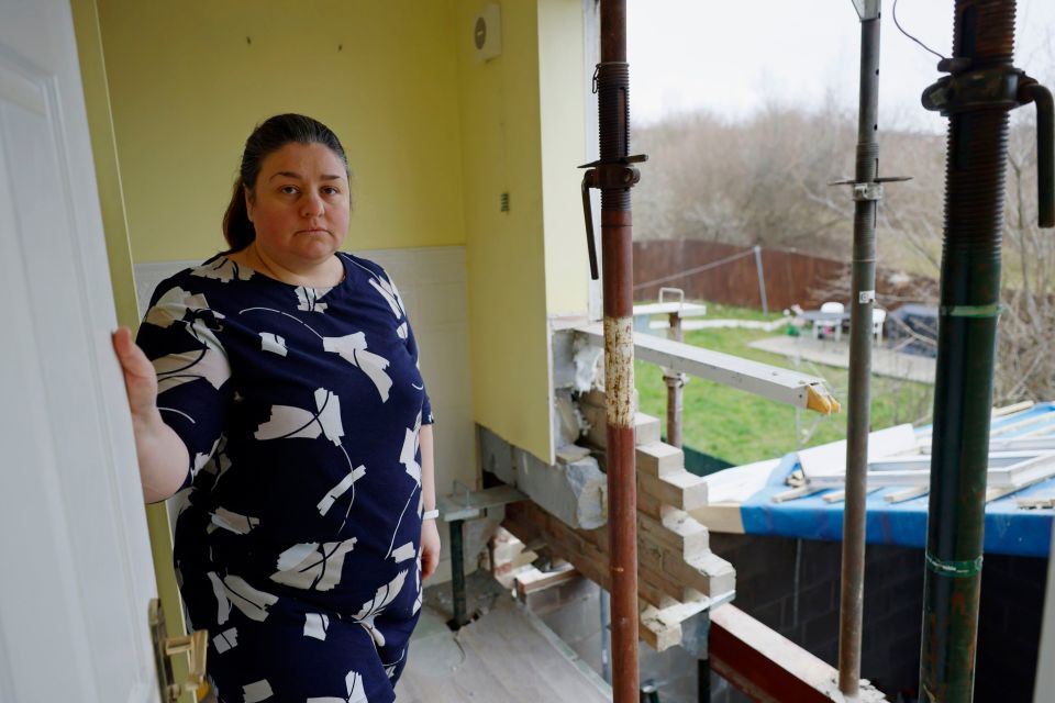 Catharine Lewis' home was left with no back wall after builders walked off the job