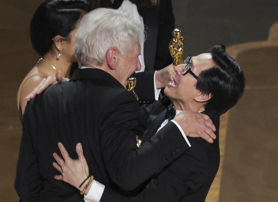 Harrison Ford hugs Ke Huy Quan following his Oscar win