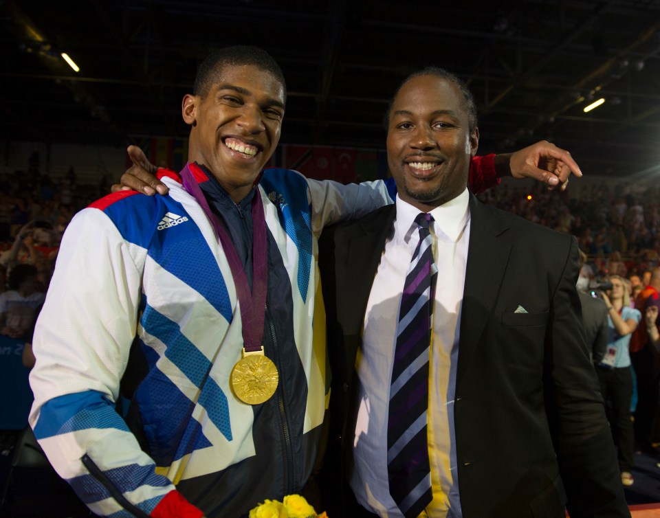 two men posing for a picture with one wearing an adidas jacket