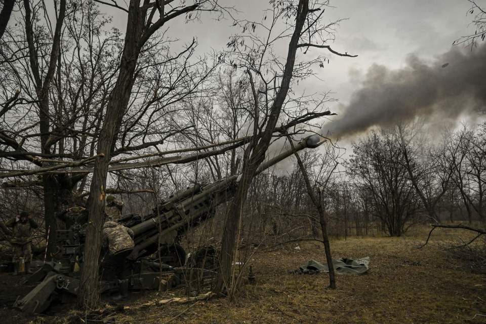 Ukrainian servicemen fire towards Russian positions with a 155mm M777 Howitzer