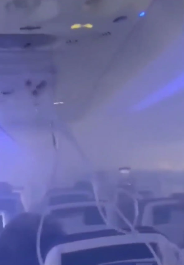 Oxygen masks can be seen as the cabin fills with smoke