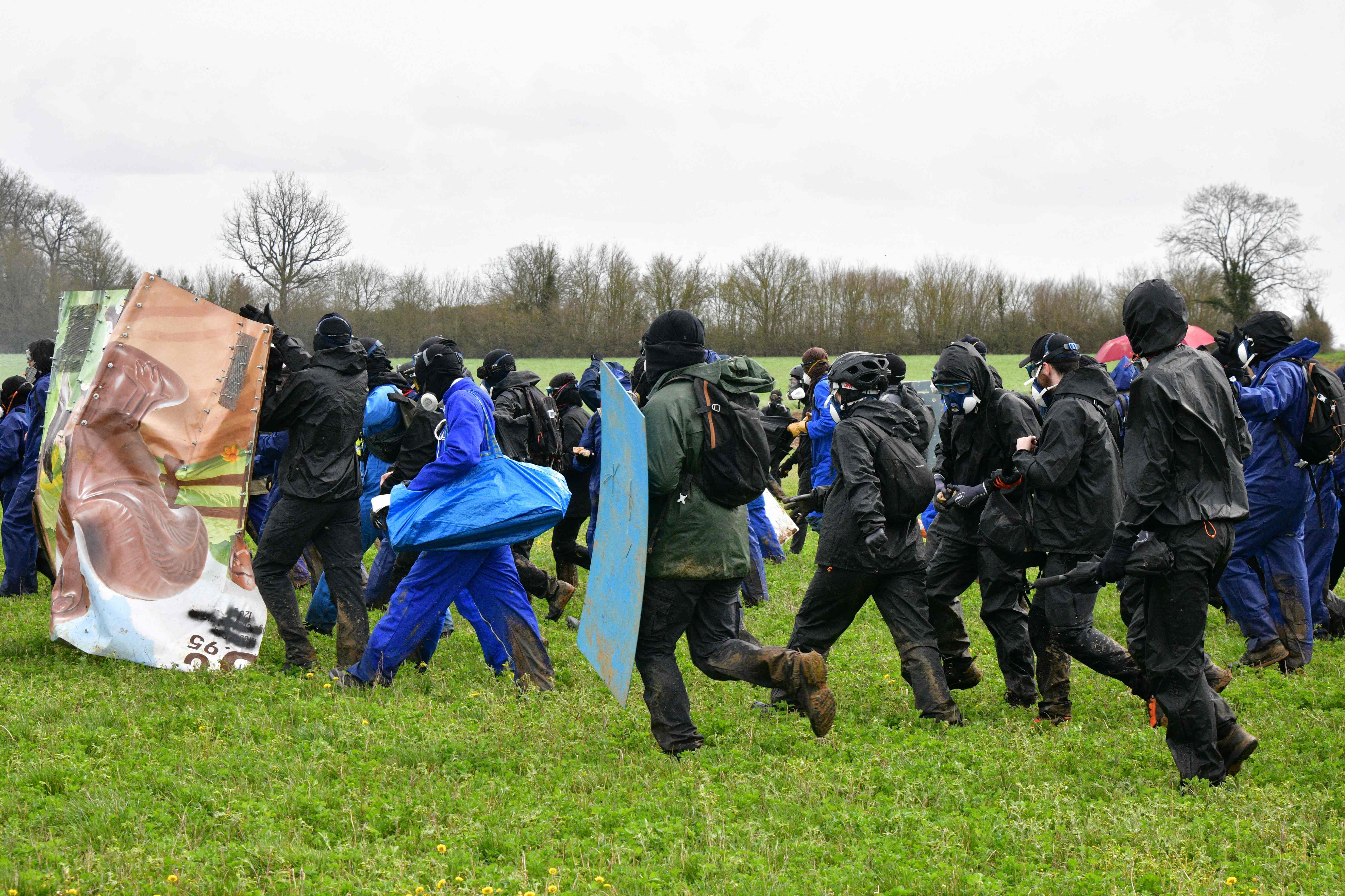 Protesters marched in the field as they demonstrated against a farm irrigation project