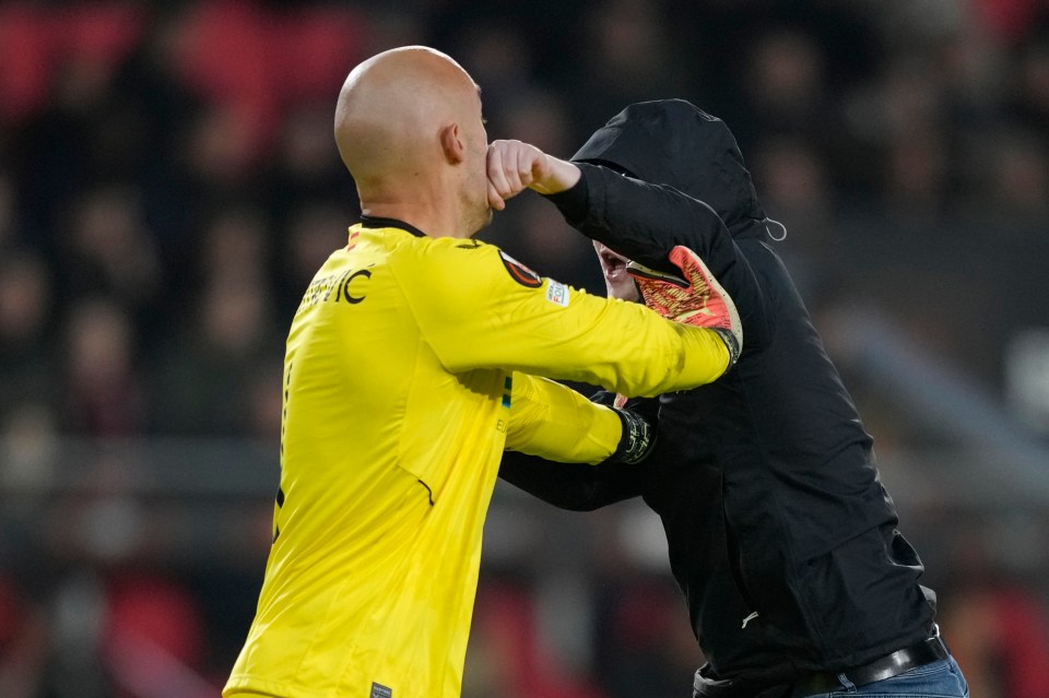 Sevilla goalkeeper Marko Dmitrovic was attacked by a pitch invader