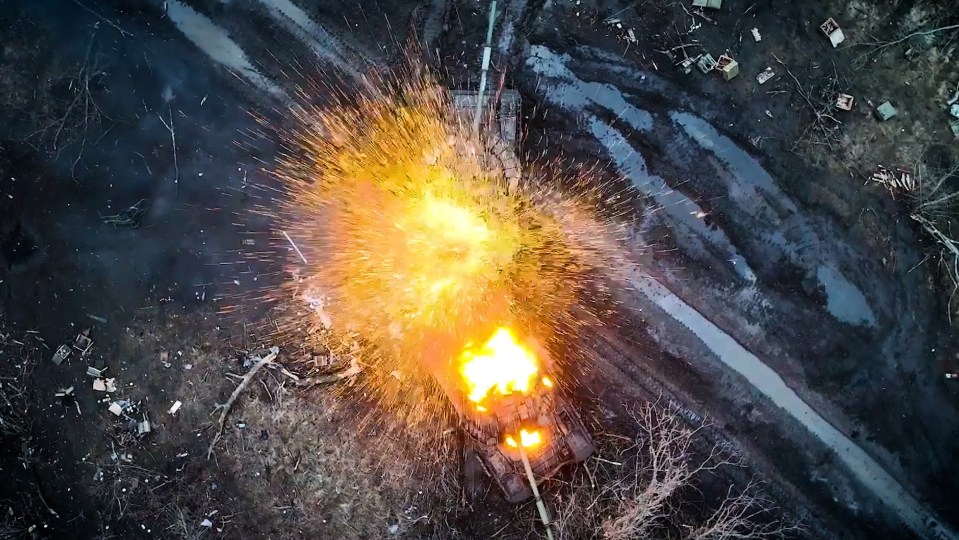 Ukrainian footage shows a Russian tank as it explodes after being hit by a bomb dropped from a drone