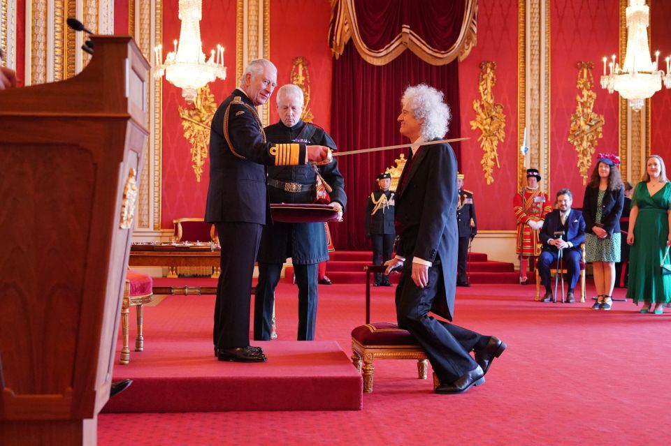 The Queen guitarist was honoured 21 years after performing on the royal residence’s roof