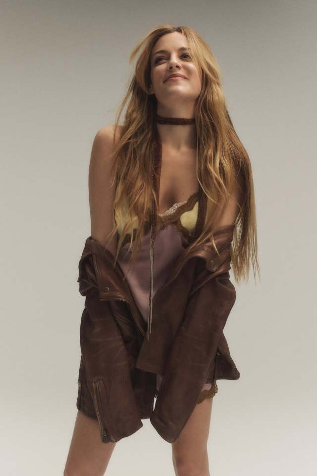 Riley Keough stunned as she posed in a silk slip dress and brown leather jacket