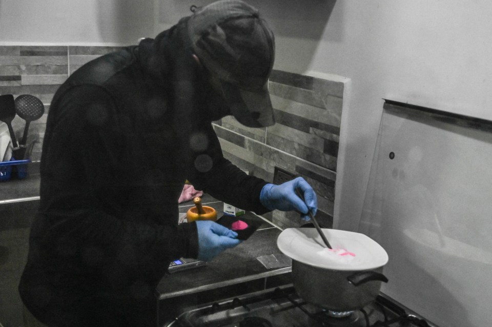 A man prepares a powder known as Tussi or pink cocaine in Medellin, Colombia