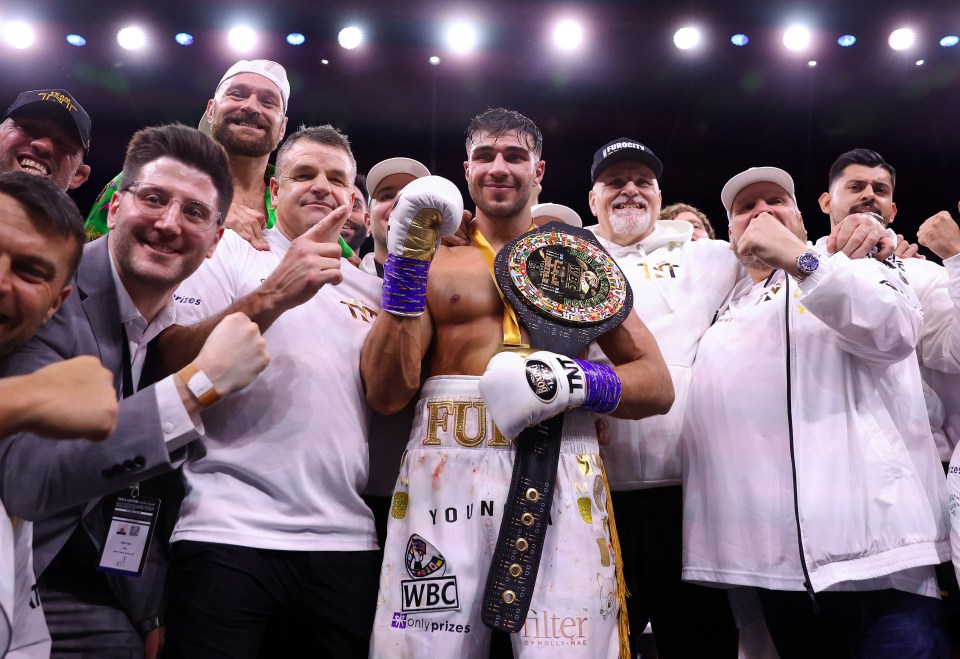 John Fury, third right, celebrates with his son Tommy in Saudi Arabia