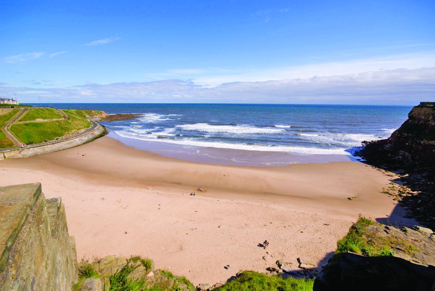 The headland overlooks the beach just around the corner from the town centre