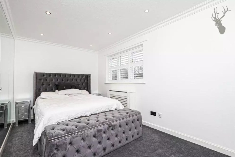 The bedroom is all white and grey - with nothing personal in there to ID it's owner