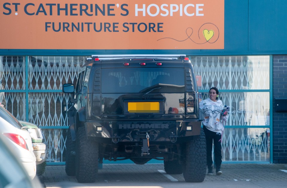 The former glamour model arrived in fiancé Carl Woods' £100k Hummer