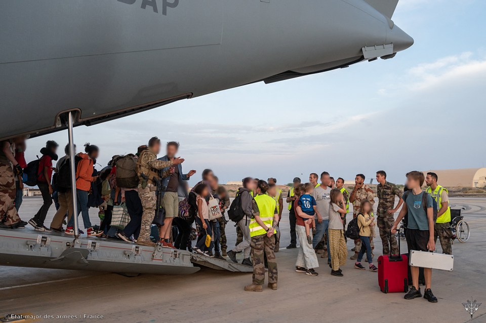 French nationals disembark from a plane at a French military air base in Djibouti on April 23