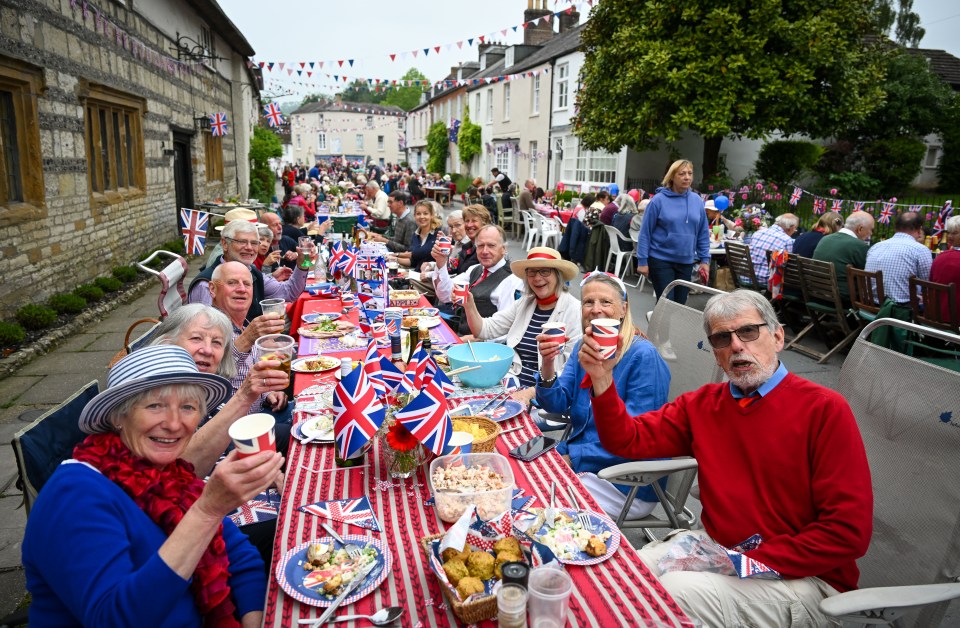 Villagers raise their glasses at a royal street party in Cerne Abbas, Dorset, in 2022