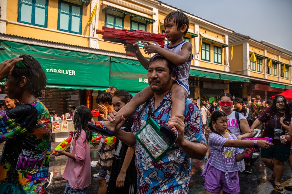 The streets of Thailand can be seen filled with vibrant colours, plastic pistols and drenched people