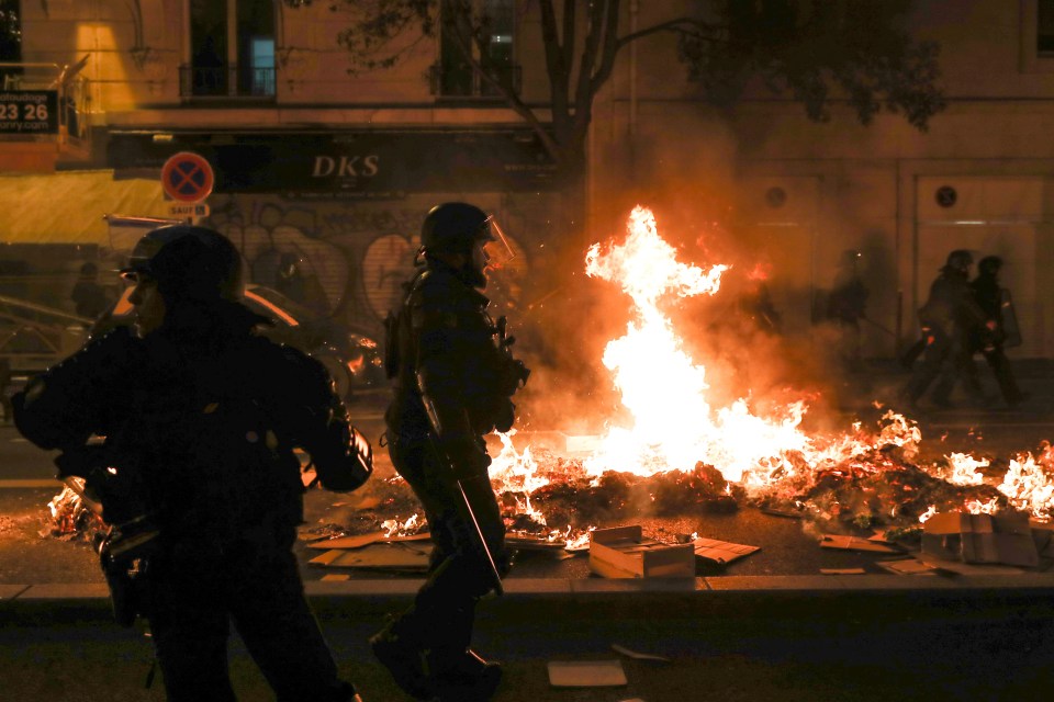 French riot police try to restore order outside the Hotel de Ville, the town hall, in Paris