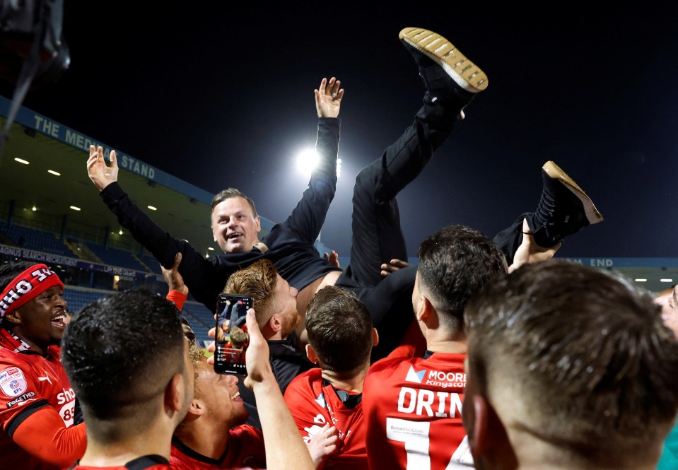 O's boss Richie Wellens is hoisted aloft by his players