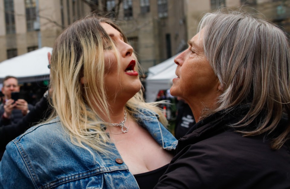 A Trump supporter, left, clashes with a rival at the court