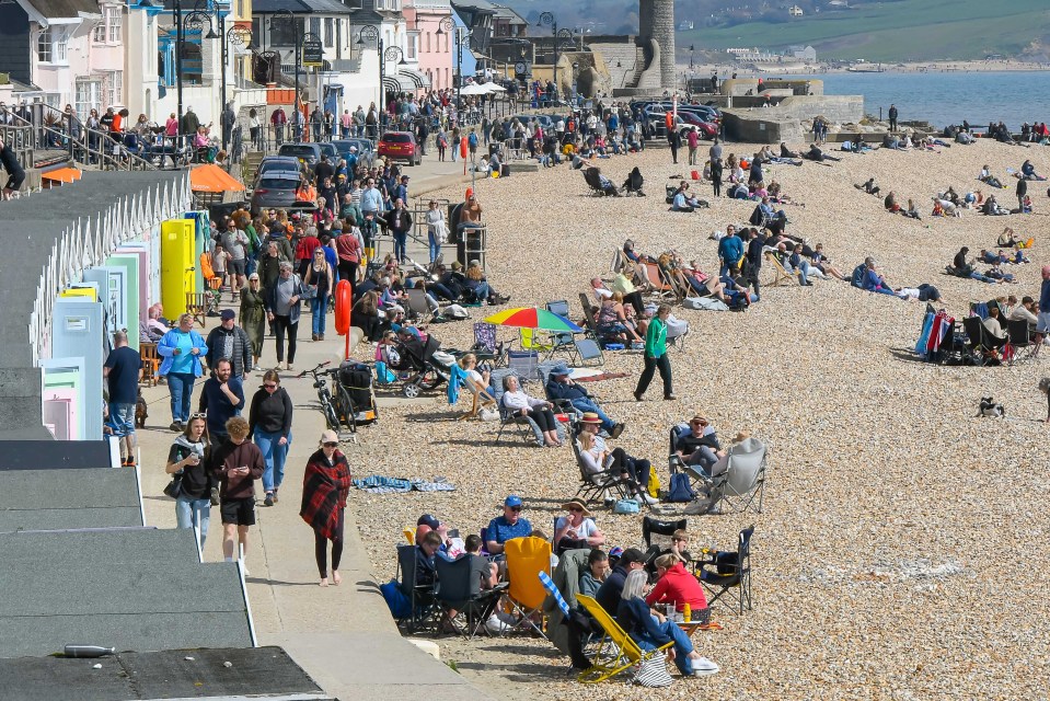 The seafront and beach is busy on the long weekend at Lyme Regis, Dorset