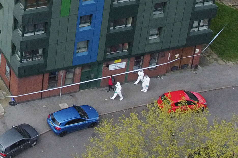 Aerial pictures show forensic staff working at the scene