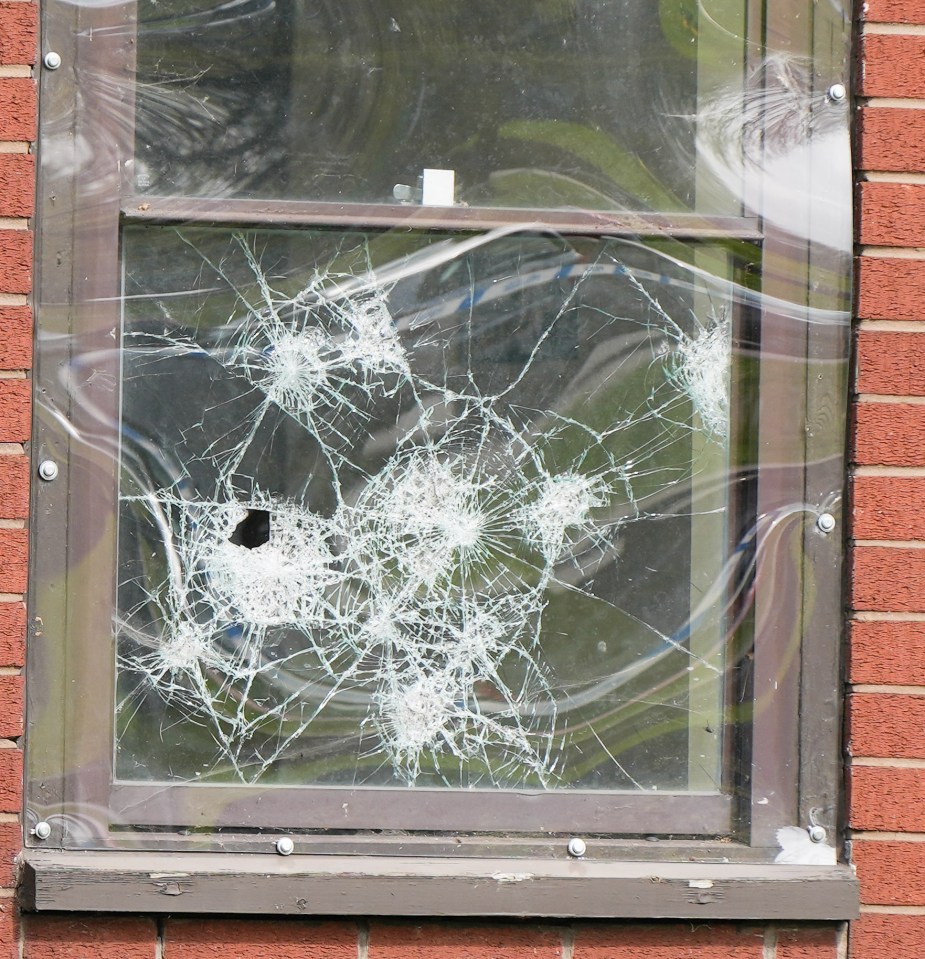 What appears to be bullet holes can be seen on a window of the estate