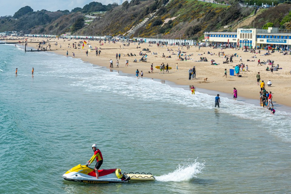 People enjoy a sunny day out on the beach in Bournemouth, Dorset, during the Easter bank holiday weekend.