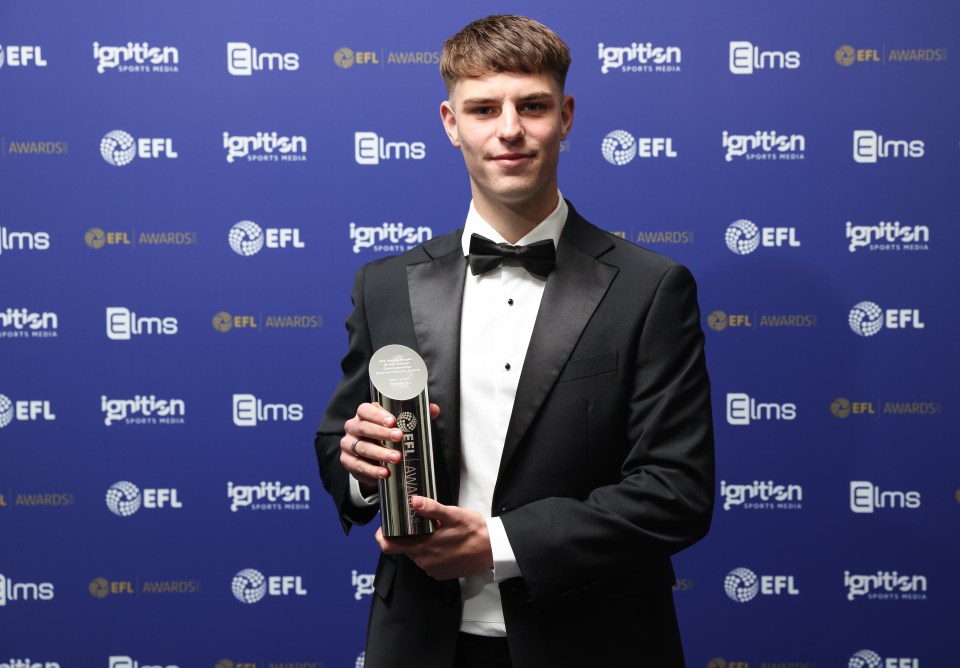 Alex Scott poses with his well-earned award