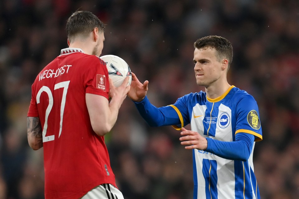 LONDON, ENGLAND - APRIL 23: Wout Weghorst of Manchester United hands the ball to the Solly March of Brighton & Hove Albion before the seventh penalty during the Emirates FA Cup Semi Final match between Brighton & Hove Albion and Manchester United at Wembley Stadium on April 23, 2023 in London, England. (Photo by Mike Hewitt/Getty Images)